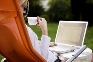 Woman working on computer outdoors