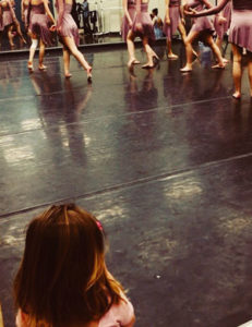 Little girl watching dancers